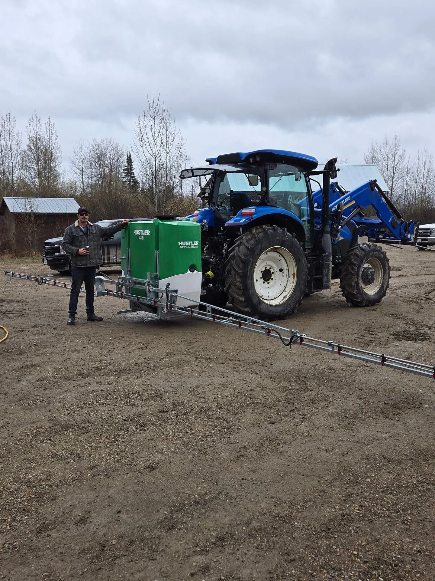 Justin Yeo with New Holland tractor and Hustler liquid applicator at JJ Cattle Co.